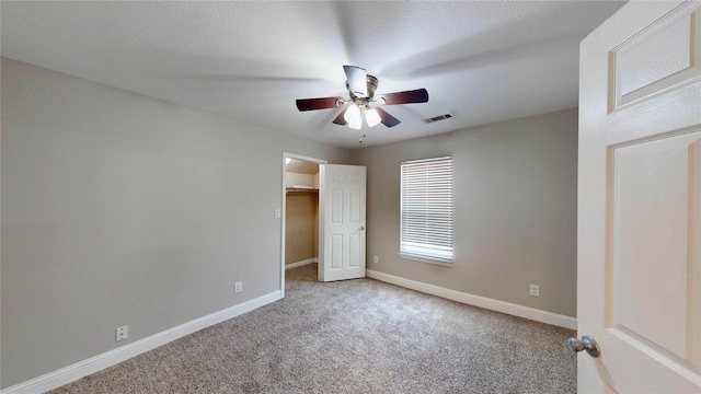 615 Royal Crest Dr, Mesquite, TX 75149 - unfurnished bedroom featuring carpet, a walk in closet, and ceiling fan