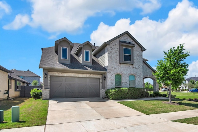 7432 Wispy Willow Ln, Little Elm, TX 76227 - view of front of home with brick siding, concrete driveway, an attached garage, and roof with shingles
