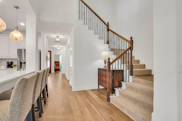 7432 Wispy Willow Ln, Little Elm, TX 76227 - entrance foyer with light wood-type flooring, stairs, recessed lighting, and a towering ceiling