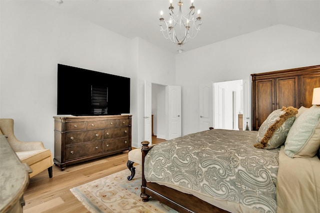 7432 Wispy Willow Ln, Little Elm, TX 76227 - bedroom featuring a chandelier, light wood finished floors, and vaulted ceiling