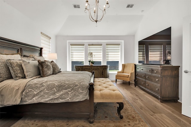 7432 Wispy Willow Ln, Little Elm, TX 76227 - bedroom featuring lofted ceiling, wood finished floors, and a chandelier