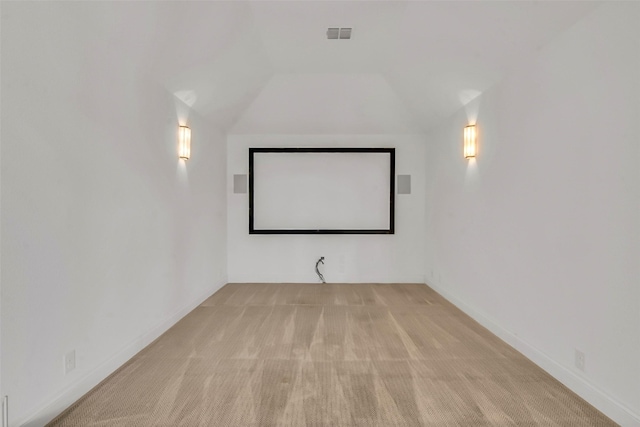 7432 Wispy Willow Ln, Little Elm, TX 76227 - carpeted cinema room featuring lofted ceiling and baseboards