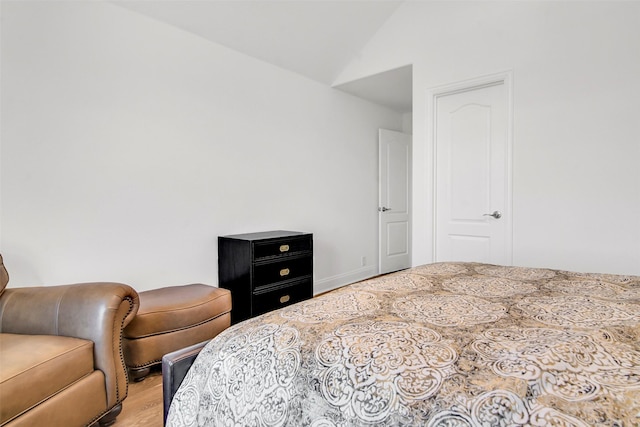 7432 Wispy Willow Ln, Little Elm, TX 76227 - bedroom with light wood finished floors and vaulted ceiling