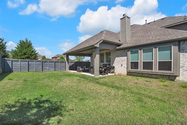 7432 Wispy Willow Ln, Little Elm, TX 76227 - back of house featuring a fenced backyard, a patio area, roof with shingles, brick siding, and an outdoor living space