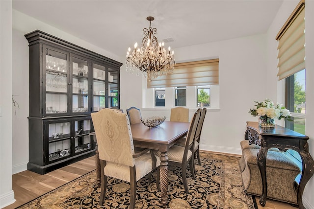 7432 Wispy Willow Ln, Little Elm, TX 76227 - dining space with a chandelier and light wood-type flooring