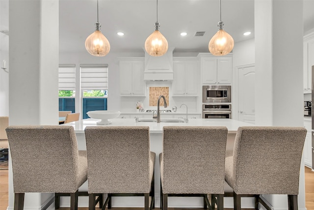 7432 Wispy Willow Ln, Little Elm, TX 76227 - kitchen featuring appliances with stainless steel finishes, recessed lighting, white cabinets, light countertops, and hanging light fixtures