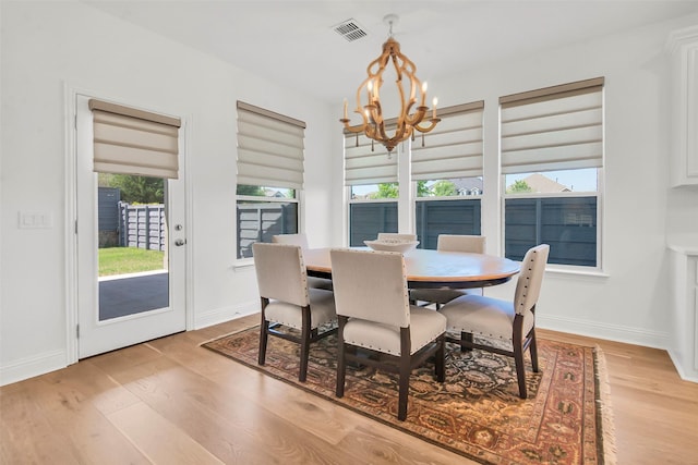 7432 Wispy Willow Ln, Little Elm, TX 76227 - dining area with a chandelier and light wood finished floors