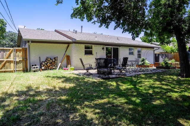 3323 Wise Dr, Mesquite, TX 75150 - back of property featuring a patio, brick siding, and roof with shingles