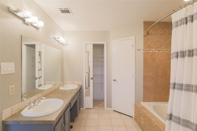 6306 Elmview Dr, Arlington, TX 76018 - full bath featuring tile patterned flooring, double vanity, tiled shower / bath, and a closet