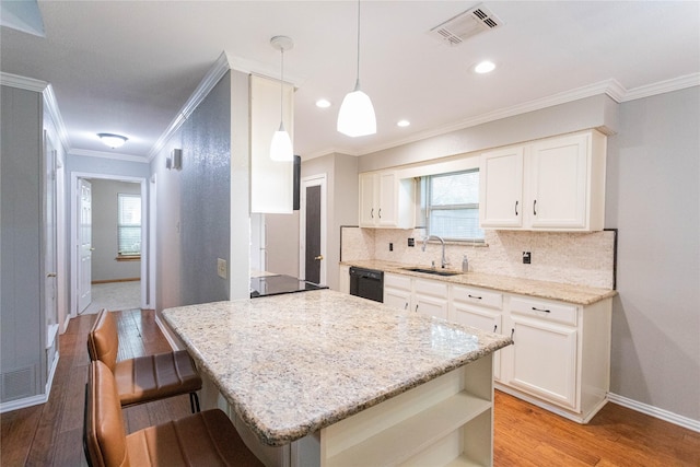 6306 Elmview Dr, Arlington, TX 76018 - kitchen featuring light wood-type flooring, backsplash, white cabinets, healthy amount of natural light, and ornamental molding