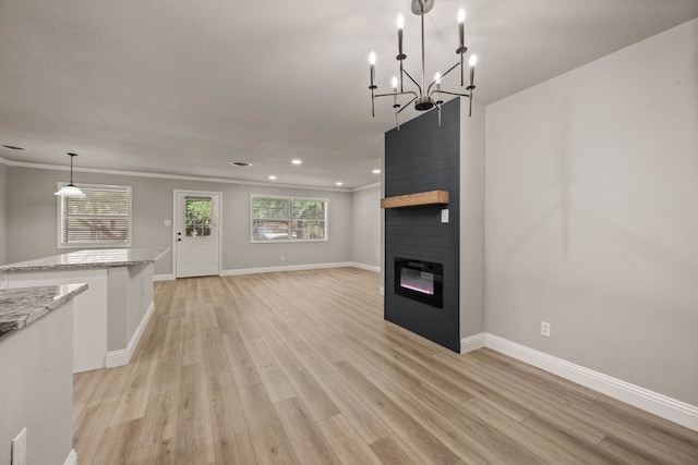 5120 Nadine Dr, Haltom City, TX 76117 - unfurnished living room with light wood-type flooring, a fireplace, recessed lighting, and a chandelier