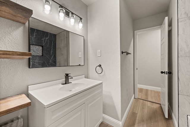 5120 Nadine Dr, Haltom City, TX 76117 - bathroom featuring wood finished floors, vanity, and a textured wall
