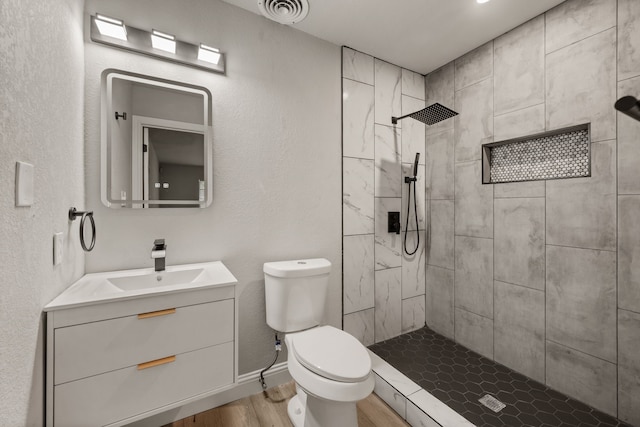5120 Nadine Dr, Haltom City, TX 76117 - bathroom featuring vanity, wood finished floors, and tiled shower