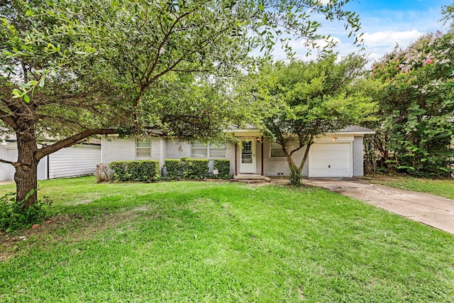 5120 Nadine Dr, Haltom City, TX 76117 - view of property hidden behind natural elements featuring brick siding, concrete driveway, an attached garage, and a front yard