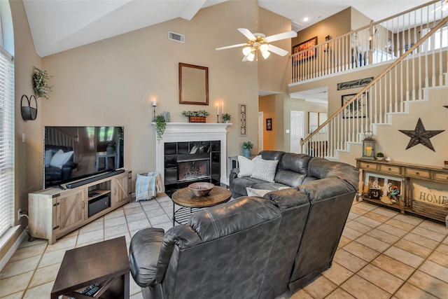 2807 Stonehurst Dr, Grapevine, TX 76051 - living room featuring ceiling fan, high vaulted ceiling, a tiled fireplace, light tile patterned floors, and stairway
