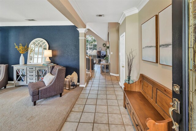 2807 Stonehurst Dr, Grapevine, TX 76051 - foyer featuring ornamental molding, an accent wall, light tile patterned floors, and ornate columns