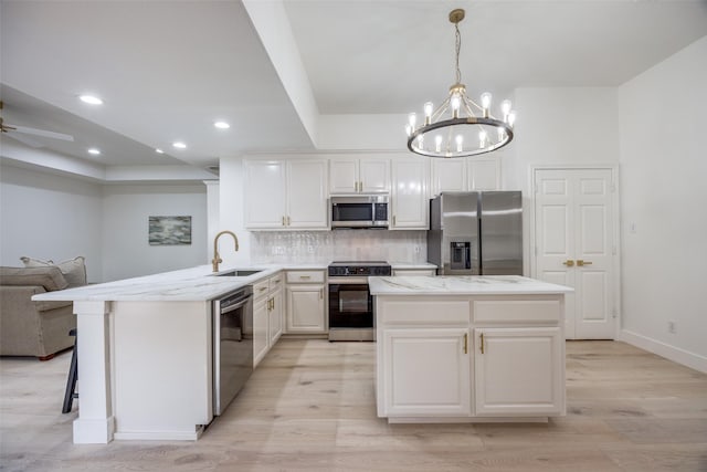 2308 Auburn Ct, Sherman, TX 75092 - kitchen with stainless steel appliances, light wood finished floors, open floor plan, decorative backsplash, and recessed lighting