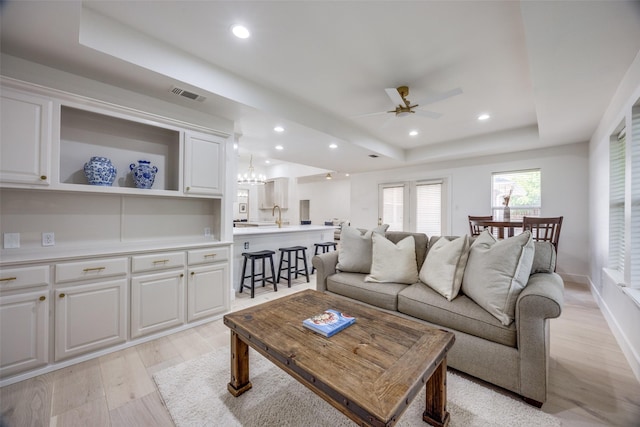 2308 Auburn Ct, Sherman, TX 75092 - living area featuring a raised ceiling, a ceiling fan, light wood finished floors, recessed lighting, and a chandelier