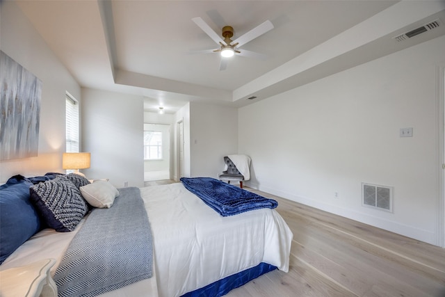 2308 Auburn Ct, Sherman, TX 75092 - bedroom featuring wood finished floors, a raised ceiling, and ceiling fan