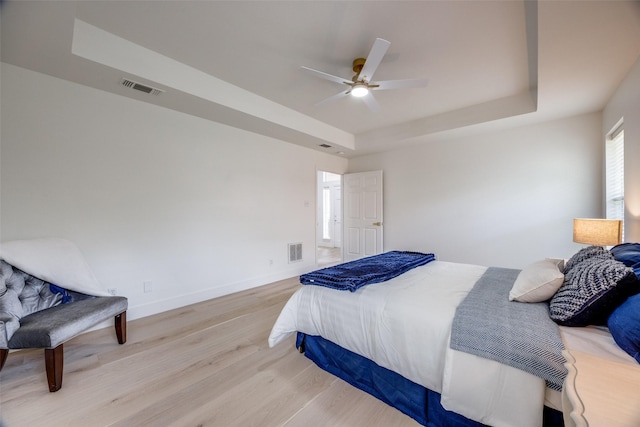 2308 Auburn Ct, Sherman, TX 75092 - bedroom featuring a tray ceiling, wood finished floors, and ceiling fan