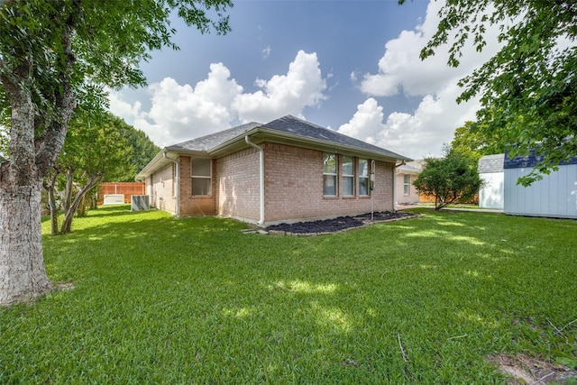 2308 Auburn Ct, Sherman, TX 75092 - rear view of property featuring brick siding and a storage unit