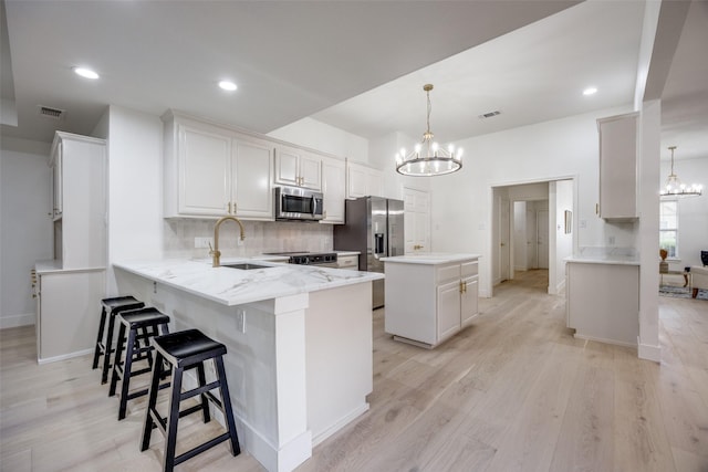 2308 Auburn Ct, Sherman, TX 75092 - kitchen featuring a chandelier, appliances with stainless steel finishes, a peninsula, a center island, and recessed lighting
