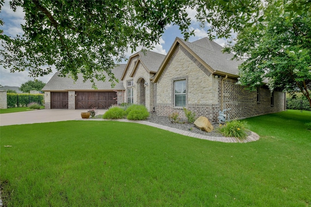 1306 Prestwick Ct, Granbury, TX 76048 - french country inspired facade featuring stone siding, concrete driveway, a front yard, a garage, and roof with shingles