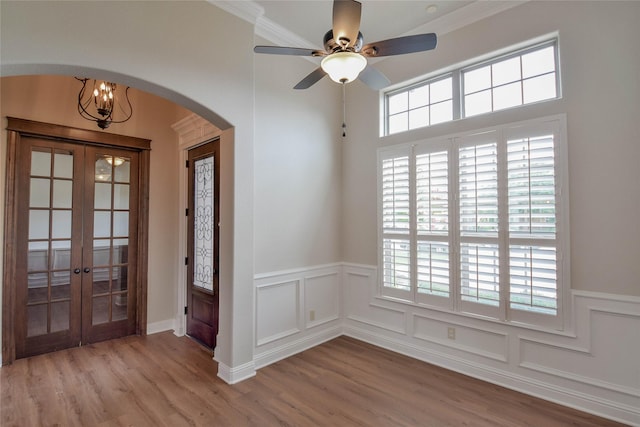 1306 Prestwick Ct, Granbury, TX 76048 - entrance foyer with arched walkways, french doors, plenty of natural light, a wainscoted wall, and ceiling fan
