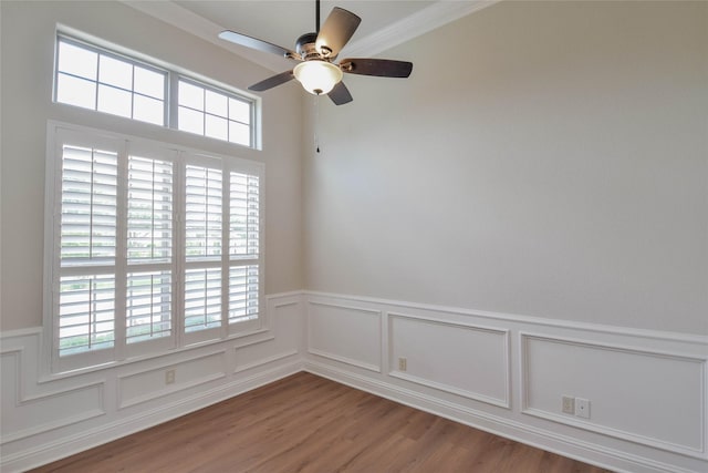 1306 Prestwick Ct, Granbury, TX 76048 - spare room featuring wainscoting, a ceiling fan, wood finished floors, a decorative wall, and crown molding