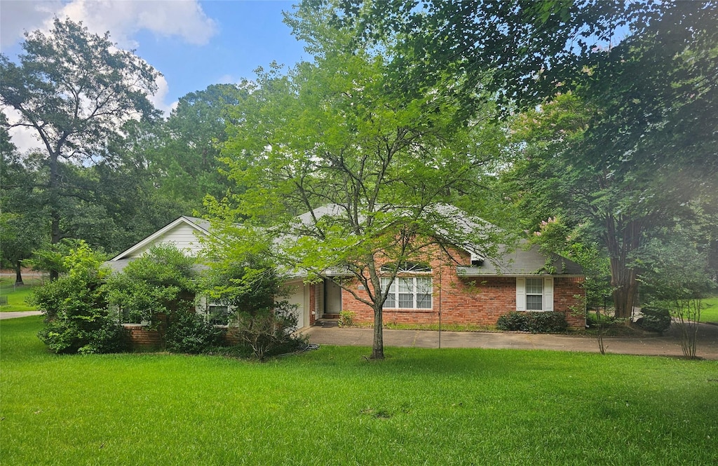 110 Woodcrest Dr, Haughton, LA 71037 - view of front facade featuring a front lawn, a garage, brick siding, and driveway