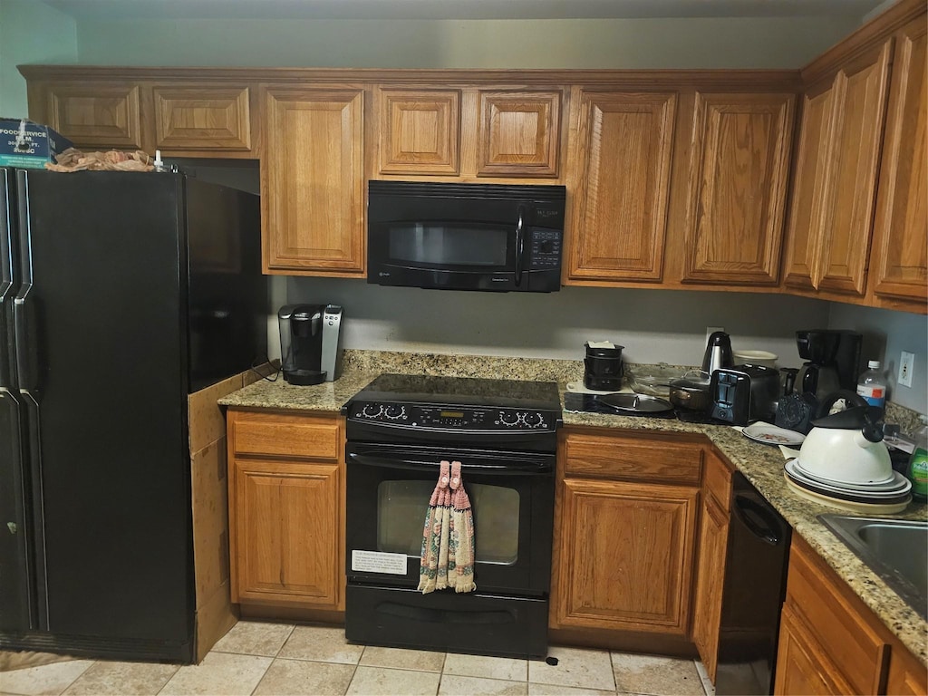 110 Woodcrest Dr, Haughton, LA 71037 - kitchen featuring black appliances, brown cabinetry, and light stone countertops