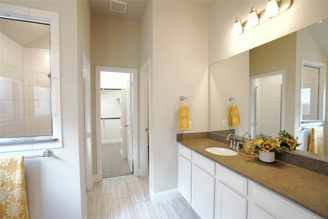 428 Gibbons Creek Trl, Mckinney, TX 75071 - bathroom with vanity, a walk in closet, and a tile shower