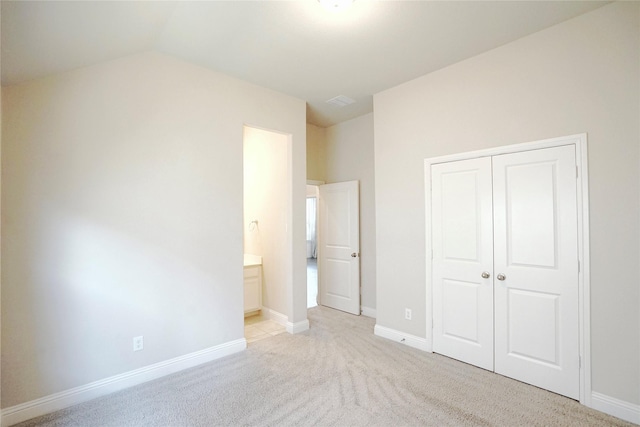 428 Gibbons Creek Trl, Mckinney, TX 75071 - unfurnished bedroom with a closet, light carpet, lofted ceiling, and ensuite bath