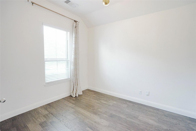 428 Gibbons Creek Trl, Mckinney, TX 75071 - spare room with wood finished floors, vaulted ceiling, and plenty of natural light