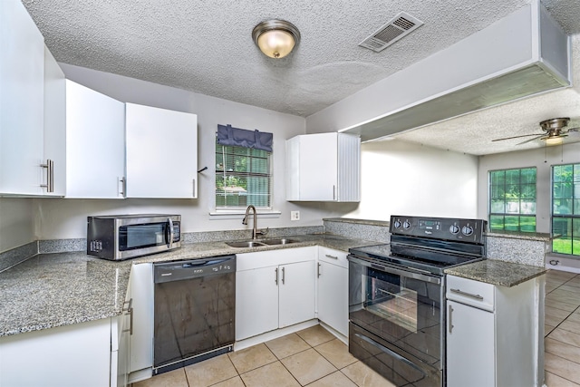 4927 Miller Ave, Fort Worth, TX 76119 - kitchen featuring black appliances, white cabinets, light tile patterned floors, a textured ceiling, and healthy amount of natural light