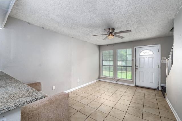 4927 Miller Ave, Fort Worth, TX 76119 - foyer entrance featuring a ceiling fan, light tile patterned flooring, and a textured ceiling