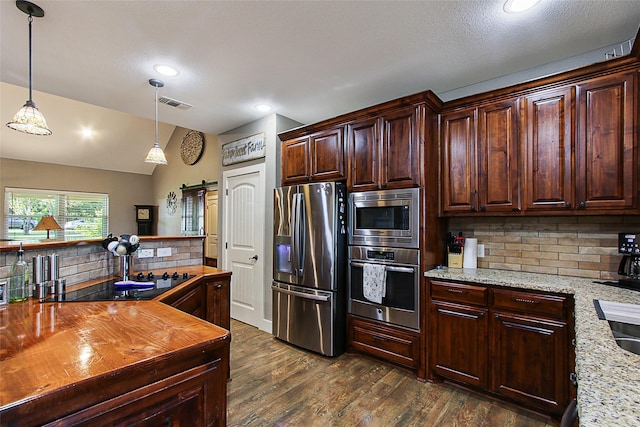 140 Stark Ln, Sherman, TX 75090 - kitchen with appliances with stainless steel finishes, butcher block countertops, a barn door, decorative backsplash, and dark wood-style flooring