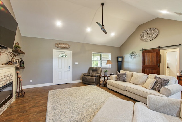 140 Stark Ln, Sherman, TX 75090 - living area with dark wood-style flooring, a ceiling fan, a barn door, high vaulted ceiling, and a brick fireplace