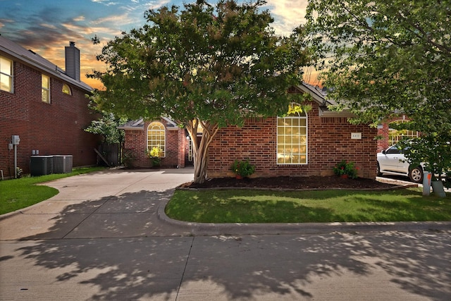4418 Spring Garden Dr, Arlington, TX 76016 - view of front of house with driveway, brick siding, and a yard