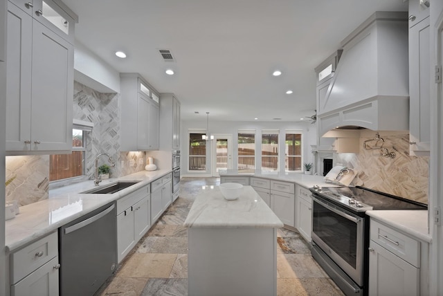 4418 Spring Garden Dr, Arlington, TX 76016 - kitchen with appliances with stainless steel finishes, backsplash, stone tile floors, custom exhaust hood, and recessed lighting