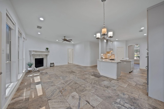 4418 Spring Garden Dr, Arlington, TX 76016 - unfurnished living room with a ceiling fan, a fireplace, arched walkways, recessed lighting, and a chandelier