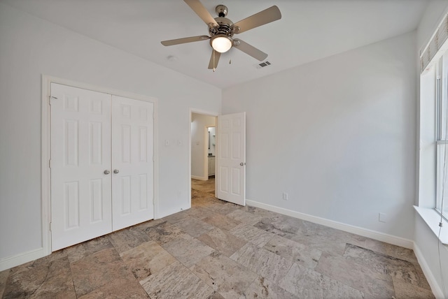 4418 Spring Garden Dr, Arlington, TX 76016 - unfurnished bedroom featuring stone finish flooring, multiple windows, a closet, and ceiling fan