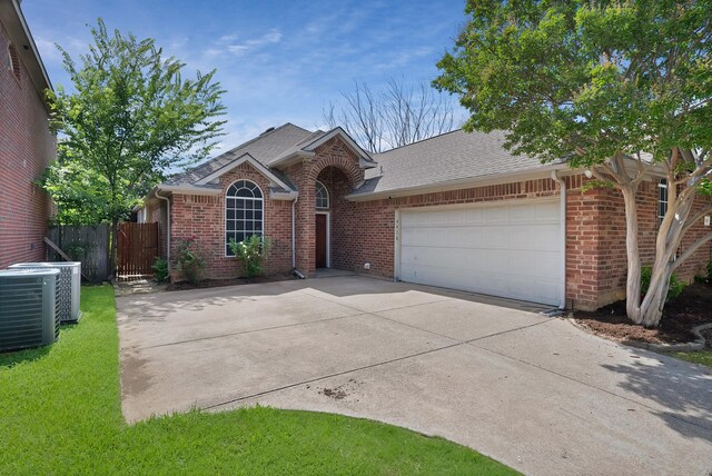 4418 Spring Garden Dr, Arlington, TX 76016 - view of front of home featuring brick siding, an attached garage, driveway, and roof with shingles
