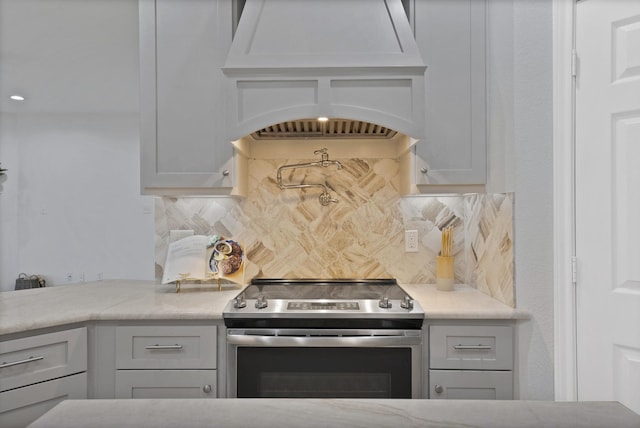 4418 Spring Garden Dr, Arlington, TX 76016 - kitchen with stainless steel range with electric cooktop, premium range hood, tasteful backsplash, and light stone countertops