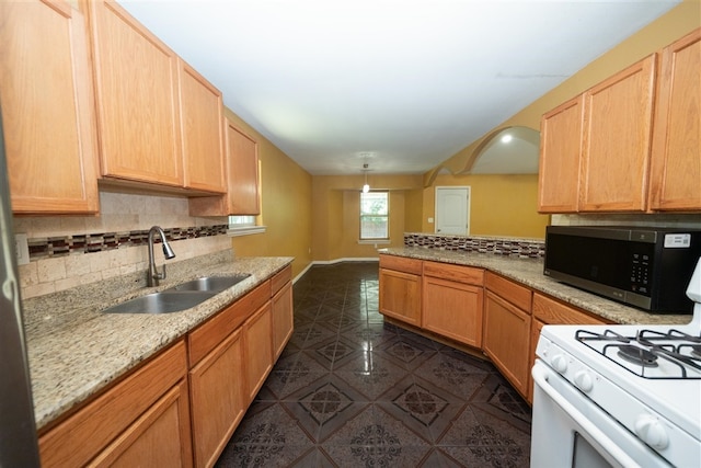 1825 E Shore Dr, Dallas, TX 75217 - kitchen featuring stainless steel microwave, white gas stove, backsplash, a peninsula, and dark tile patterned floors