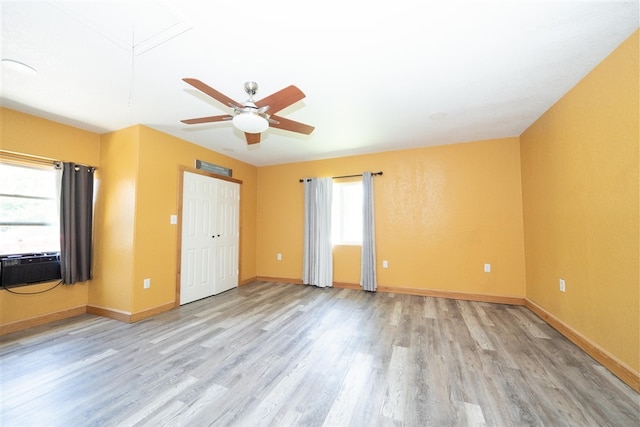 1825 E Shore Dr, Dallas, TX 75217 - unfurnished bedroom with light wood finished floors, a ceiling fan, and cooling unit