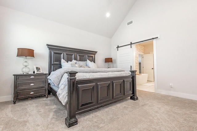 9209 Old Stoney Rd, Ponder, TX 76259 - bedroom featuring light colored carpet, high vaulted ceiling, a barn door, and connected bathroom