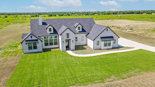 9209 Old Stoney Rd, Ponder, TX 76259 - view of front of property featuring board and batten siding, a chimney, brick siding, a front yard, and a view of countryside