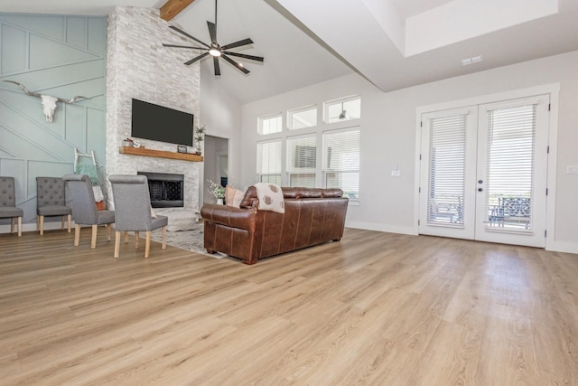 9209 Old Stoney Rd, Ponder, TX 76259 - living area with wood finished floors, a fireplace, ceiling fan, plenty of natural light, and high vaulted ceiling