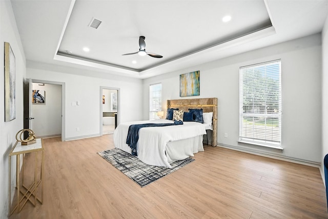 901 Bluebird Ct, Burleson, TX 76028 - bedroom featuring a tray ceiling, light wood finished floors, recessed lighting, ceiling fan, and ensuite bathroom